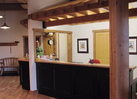 The front desk at the practice, framed by timber posts